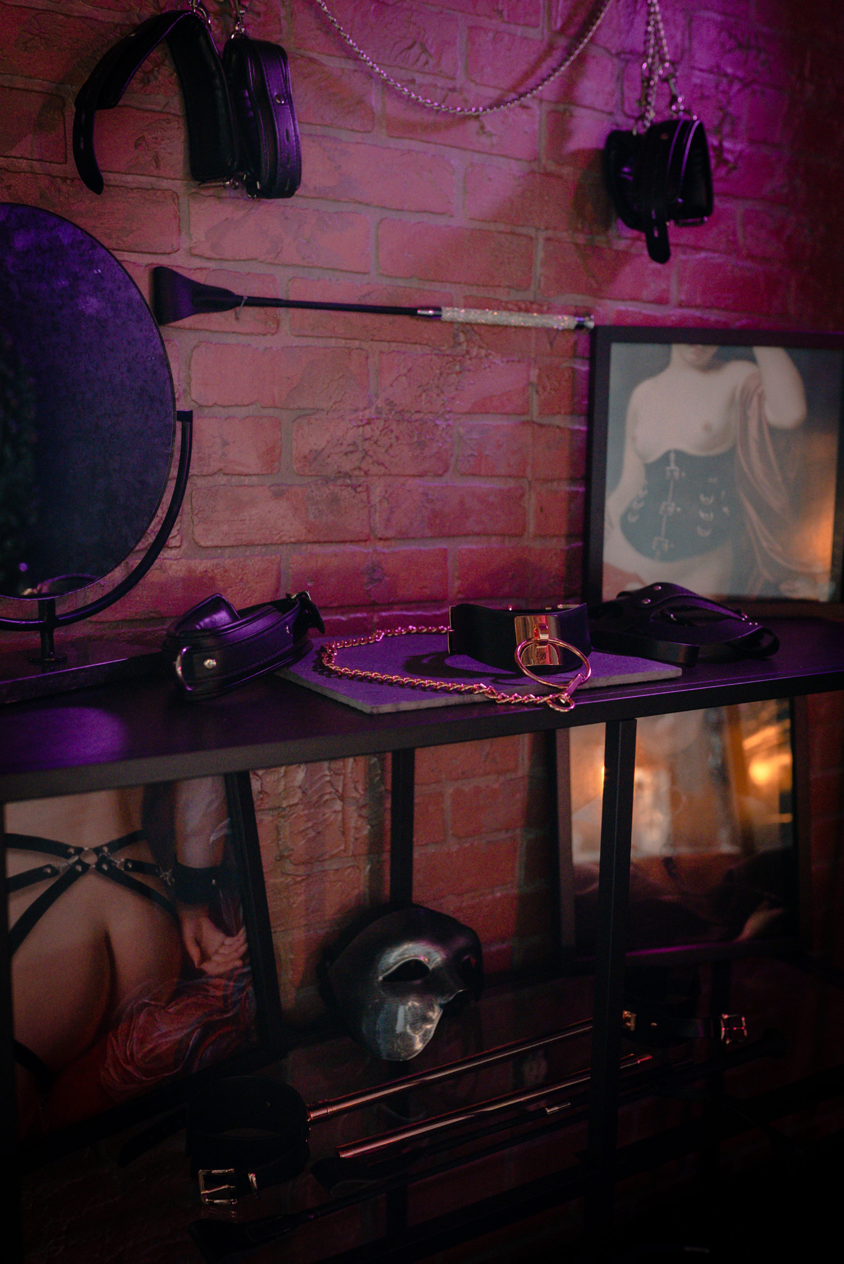 BDSM Toys are showcased on a wall and table
