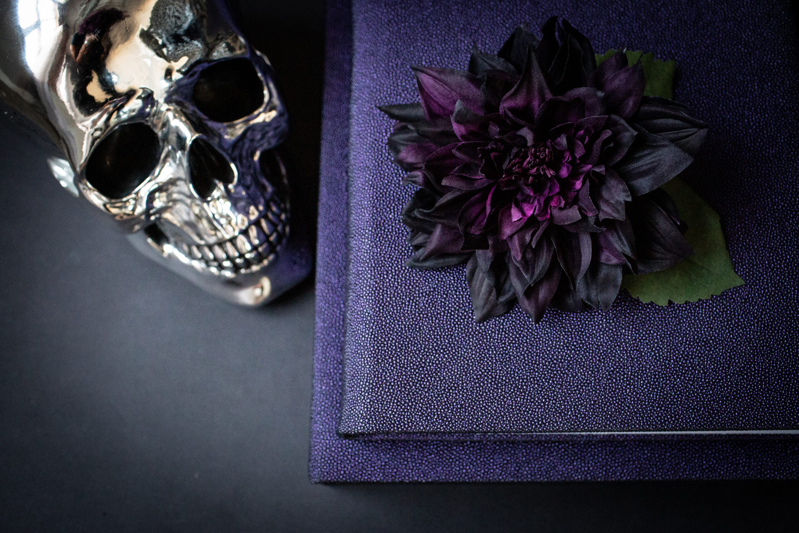 Open bridal boudoir photo album showing images of a bride in white lingerie and veil.