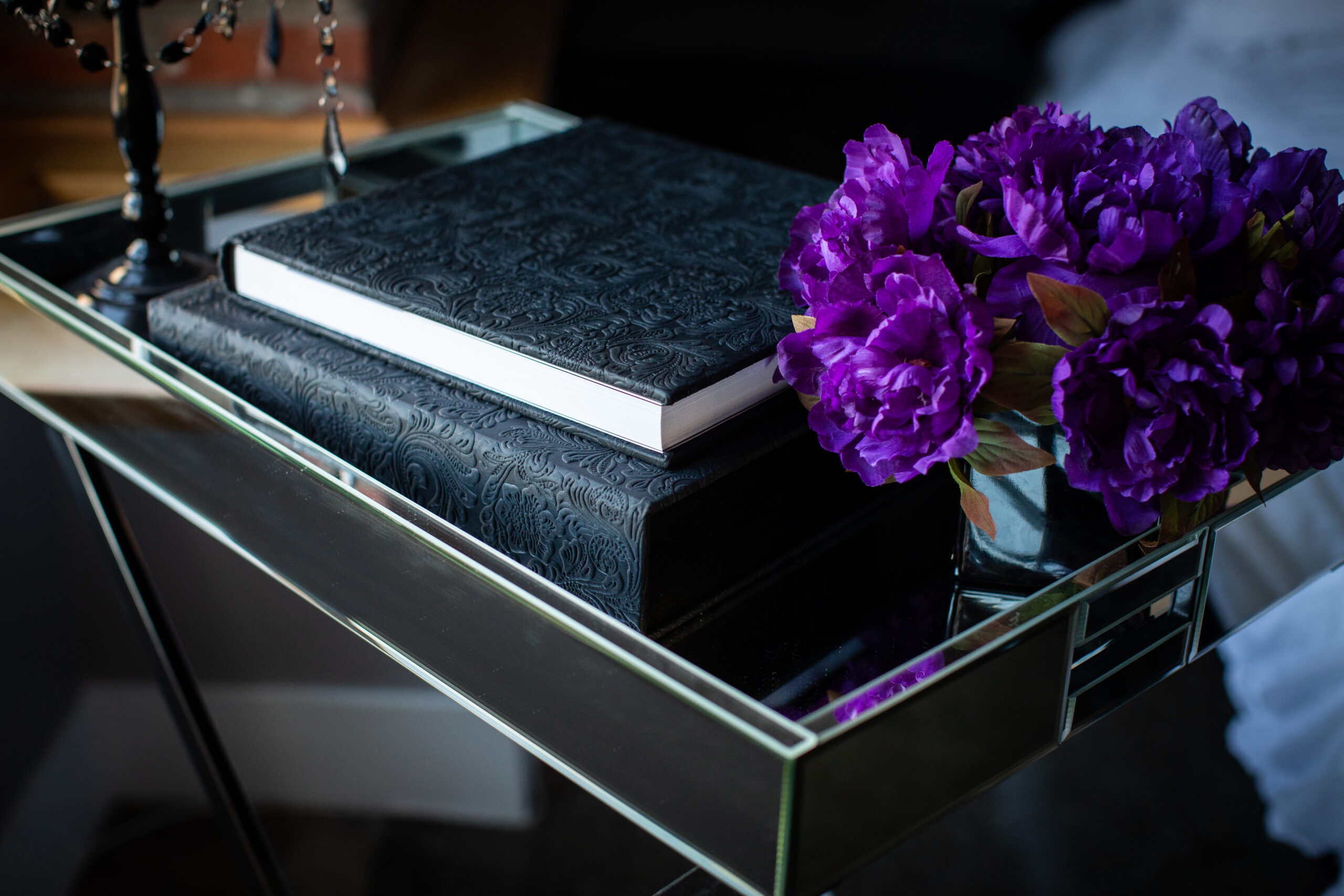 Stack of bridal boudoir albums in different cover finishes, designed for Virginia Beach brides.